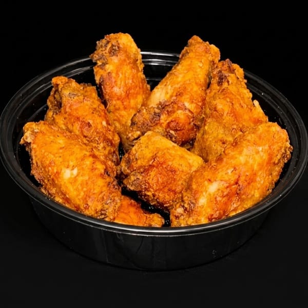 Crispy, golden-brown fried chicken wings served in a black takeout bowl.